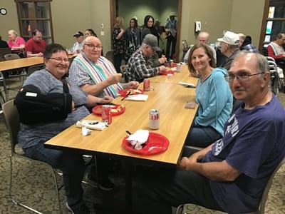 Residents enjoying a meal together at a common area.