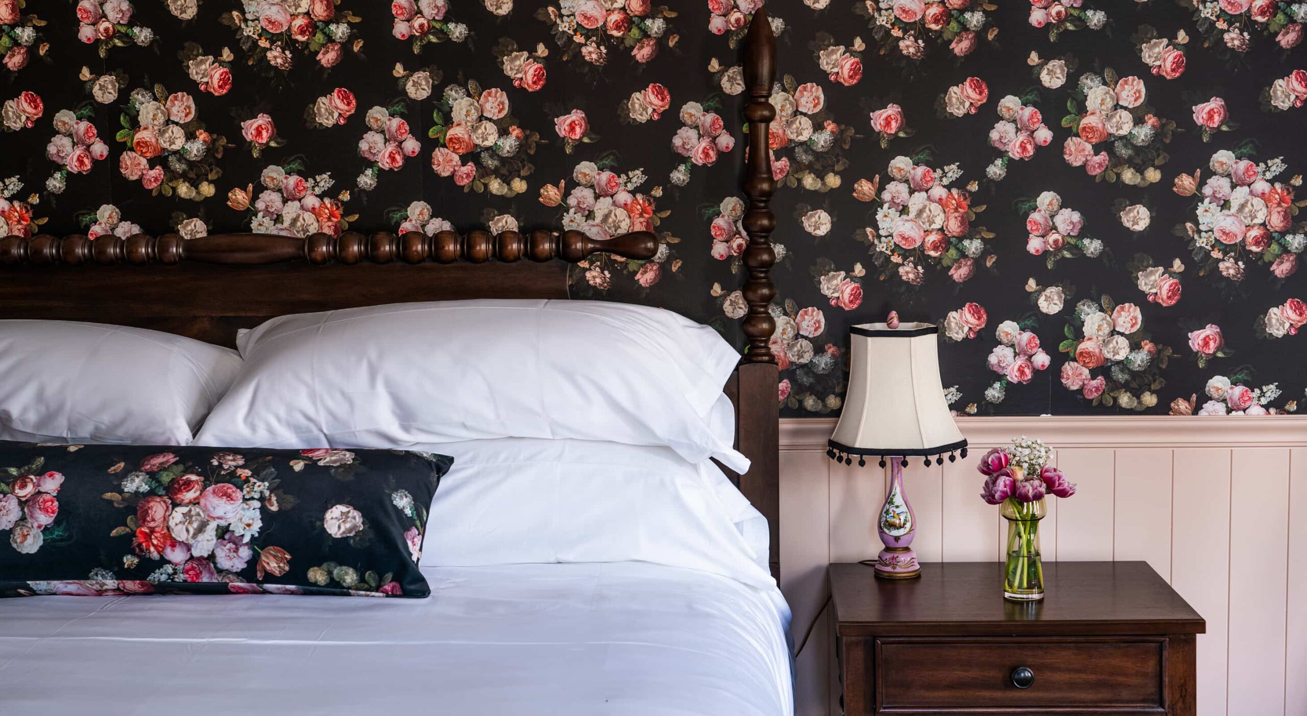 Cozy bedroom setup with floral wallpaper