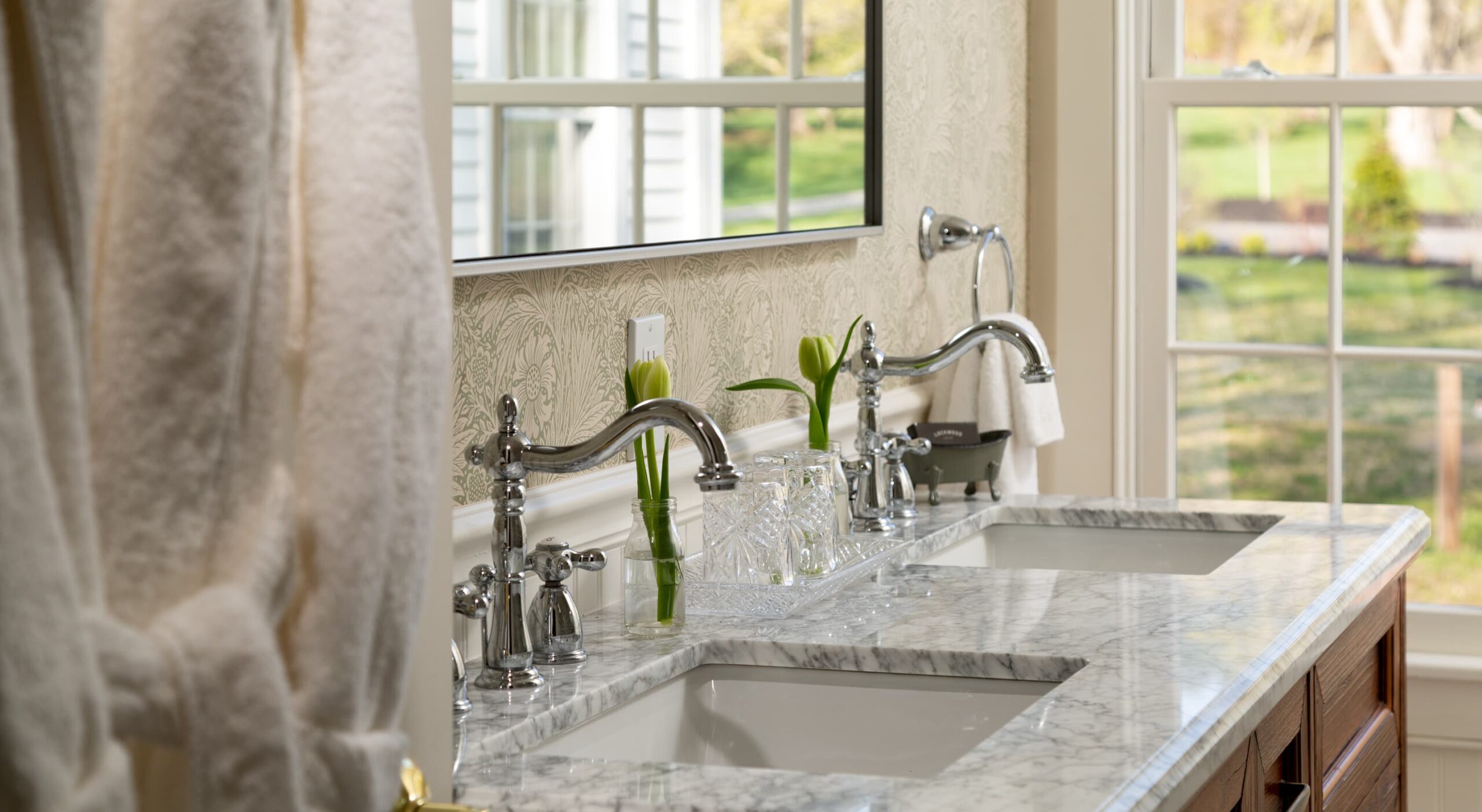 Elegant bathroom with double sinks and natural light.