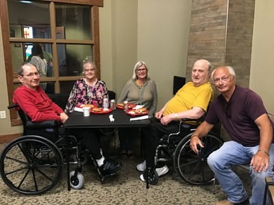 Residents enjoying a meal together in a common area.
