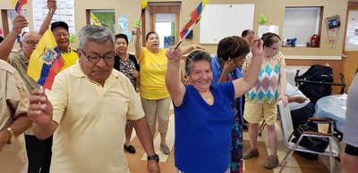 Residents celebrating with flags during an activity