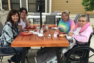 Residents enjoying a meal outdoors together.