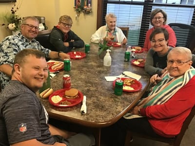 Residents enjoying a meal together at a dining table.