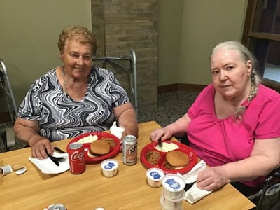 Two residents enjoying a meal together