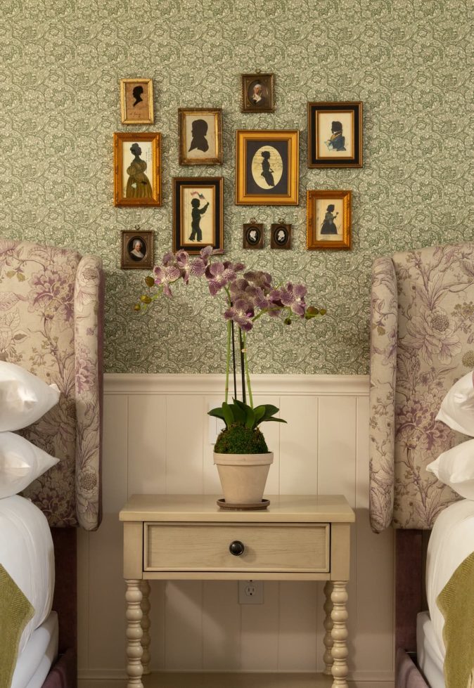 Elegant guest room with floral decor and artwork.