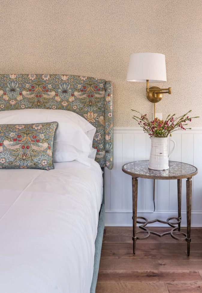 Well-decorated bedroom featuring floral patterns and wooden accents.