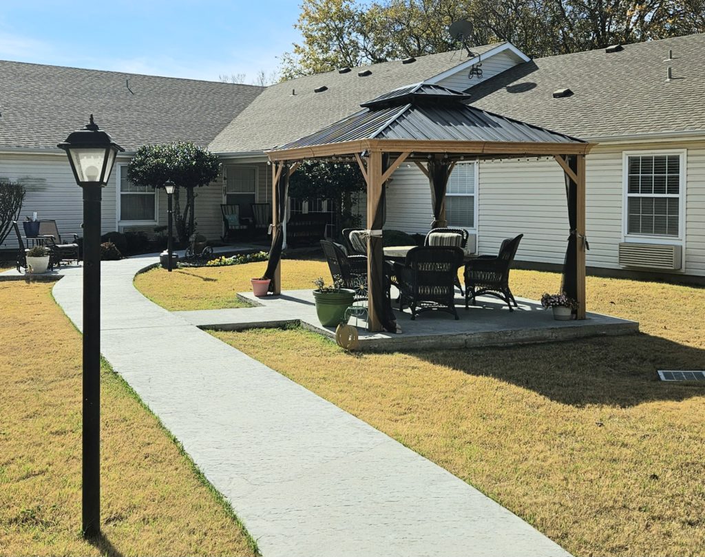 Outdoor seating area with gazebo and pathway.