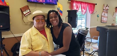 Two people smiling together at a celebration