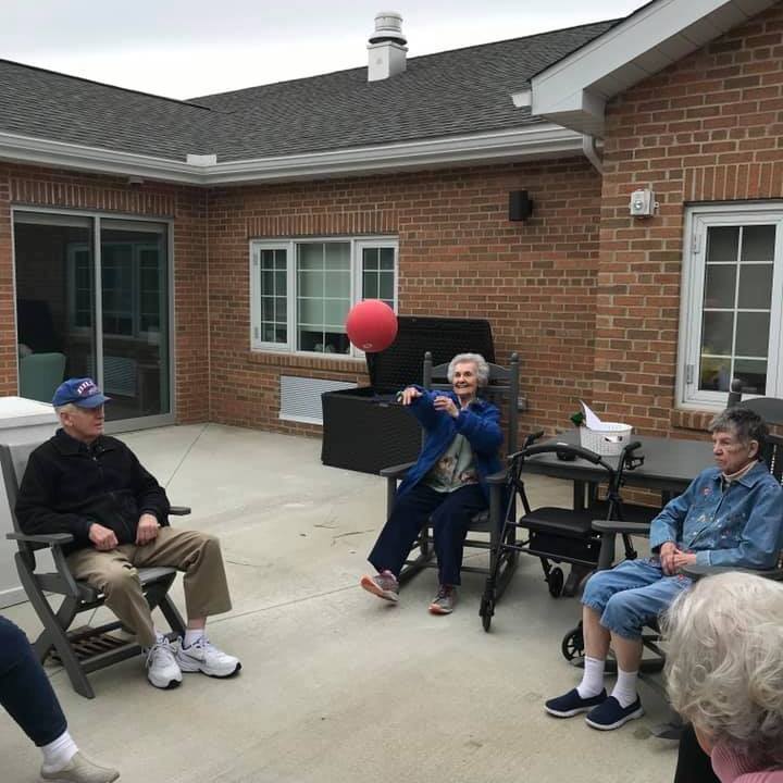Seniors playing with a ball in an outdoor space.