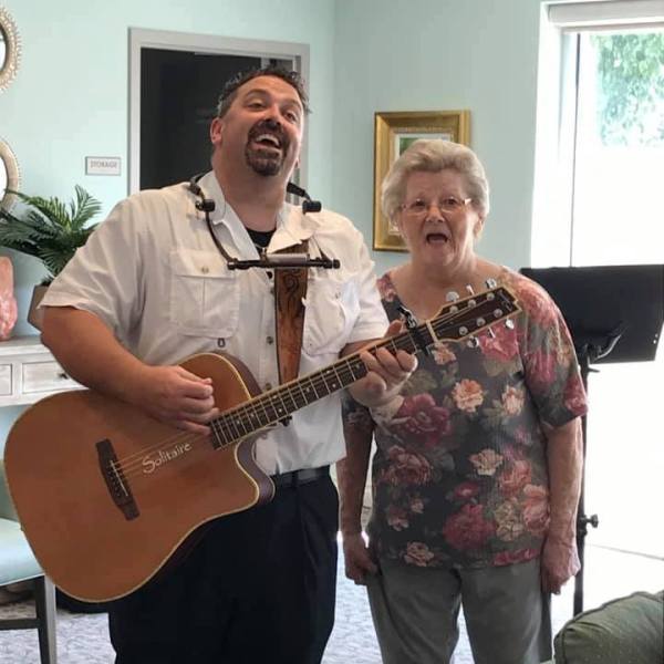Musician performing with a resident singing along.