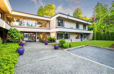Exterior view of Greenridge Estates with garden and pathway.