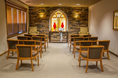Cozy communal space with chairs and stained glass