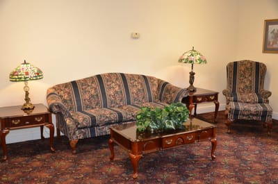 Cozy common area with floral-patterned furniture.