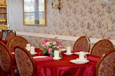 Elegant dining room setup with floral centerpiece.