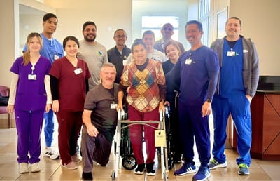 Staff and residents posing together in a common area