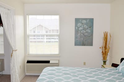 Bright resident bedroom with decorative elements.