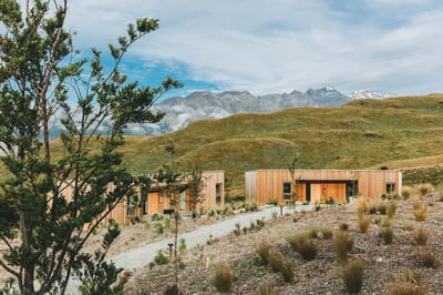 Modern buildings set against a mountainous landscape.