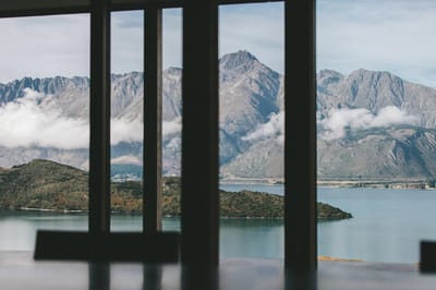 Scenic view of mountains and water through windows.