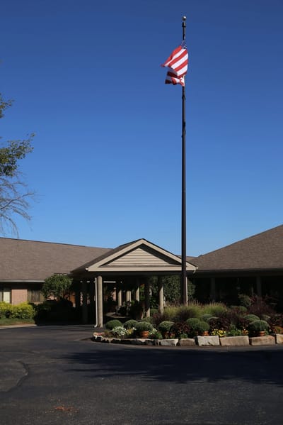 Building entrance with flag and landscaped area
