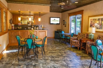 Cozy dining area with tables and chairs.