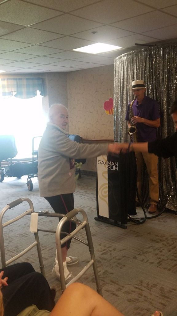Residents enjoying a musical performance in a common area.