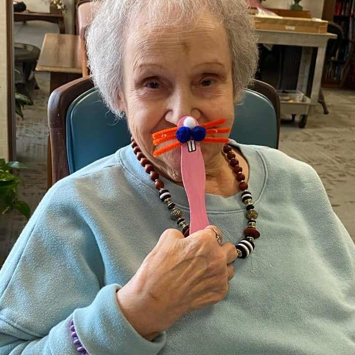 Resident playing with a creative craft project.