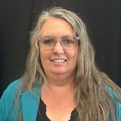 Portrait of a staff member with long hair.