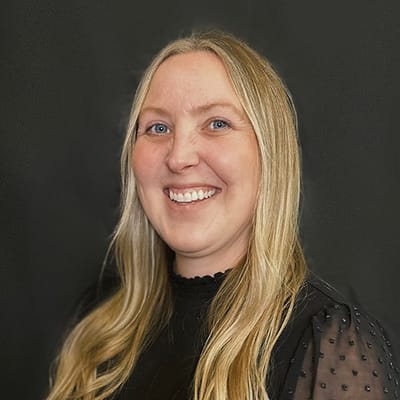 Smiling staff member with long hair