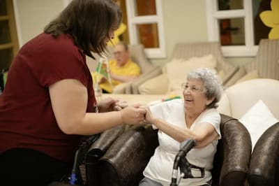 Staff member interacting with a resident in a lounge