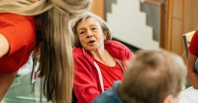 Engaged conversation between staff and resident.