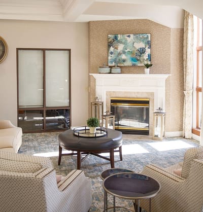 A cozy common area with seating and a fireplace