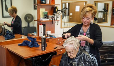 Resident receiving a haircut in the salon