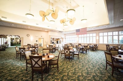 Dining area with tables and chairs and an American flag.