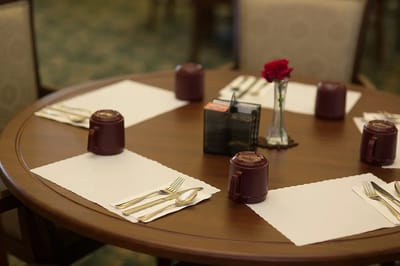 Dining table set for a meal with flowers.