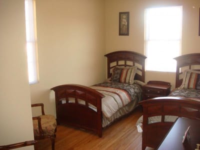 Shared resident bedroom with two beds.
