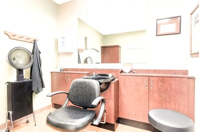 Hair salon area with chair and sink