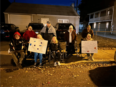 Residents holding signs outdoors