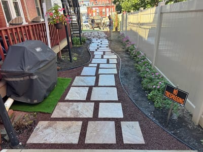 Pathway with pavers and flowers in outdoor space.
