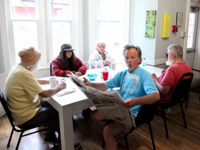 Residents enjoying a meal and conversation.