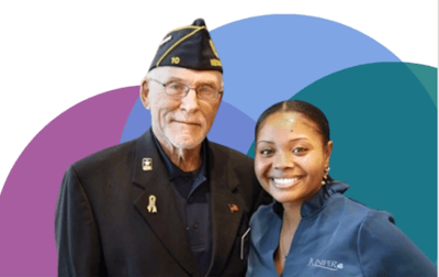 A veteran and a staff member smiling together