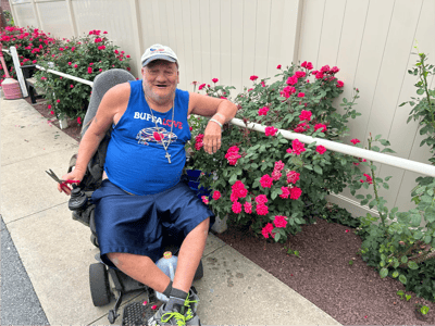 Resident enjoying the garden with roses