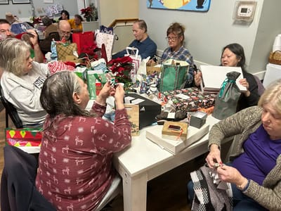 Residents enjoying a gift-wrapping activity together.