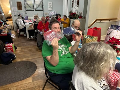 Residents celebrating with gifts and decorations
