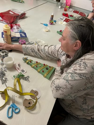 Resident participating in a holiday crafting activity.