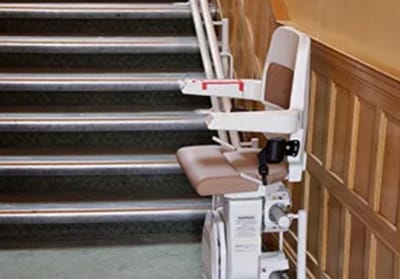 Stairlift positioned at the bottom of a staircase.
