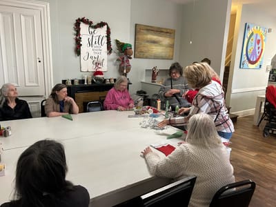 Residents participating in a craft activity indoors.