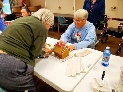 Residents engaging in a gingerbread house activity.