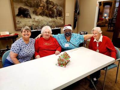 Residents and staff celebrate together indoors.