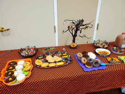 Decorative table with Halloween-themed snacks and drinks.