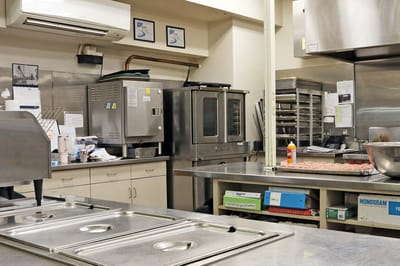 Commercial kitchen with cooking equipment and utensils